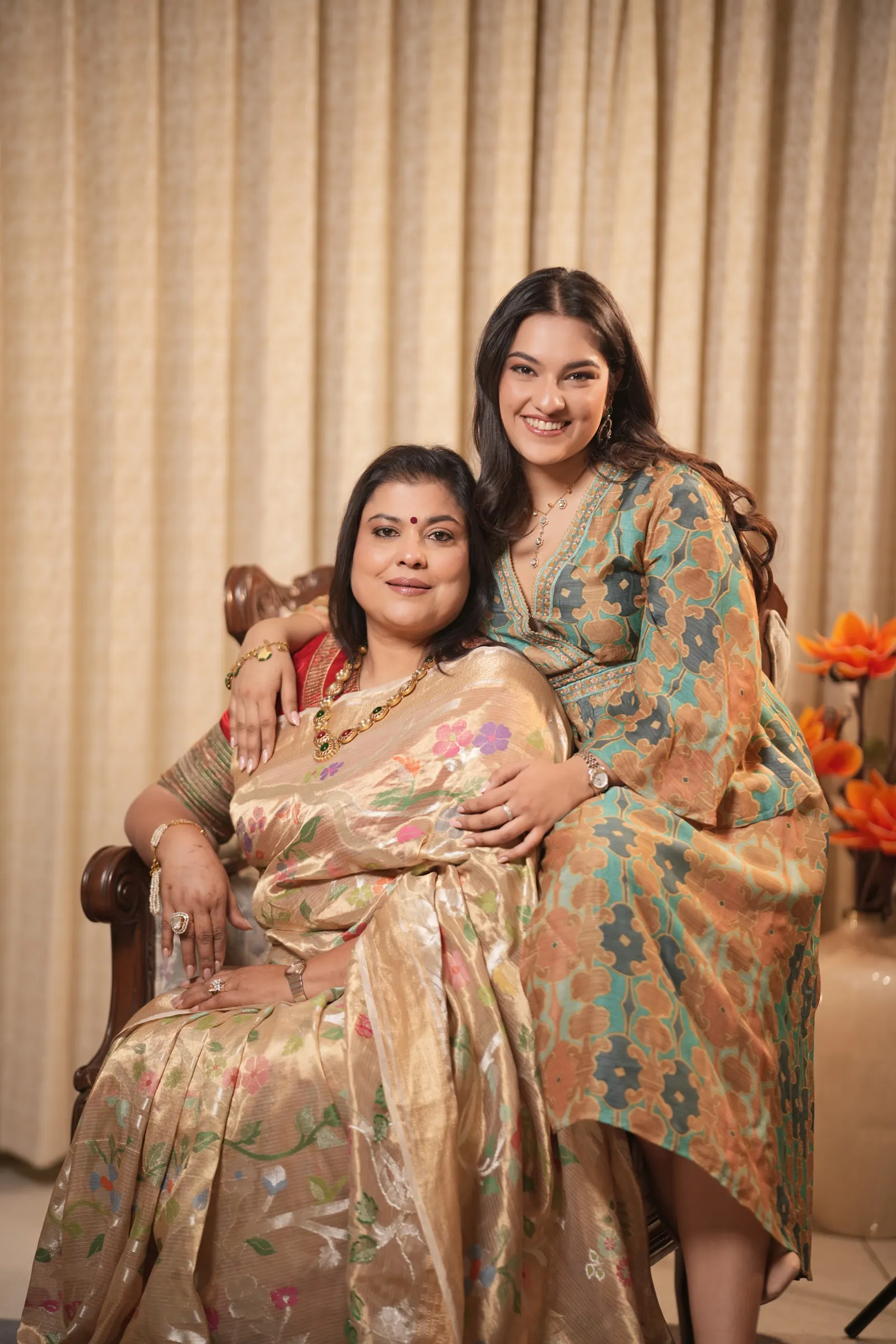 Mansi seated, with Khushi standing beside her